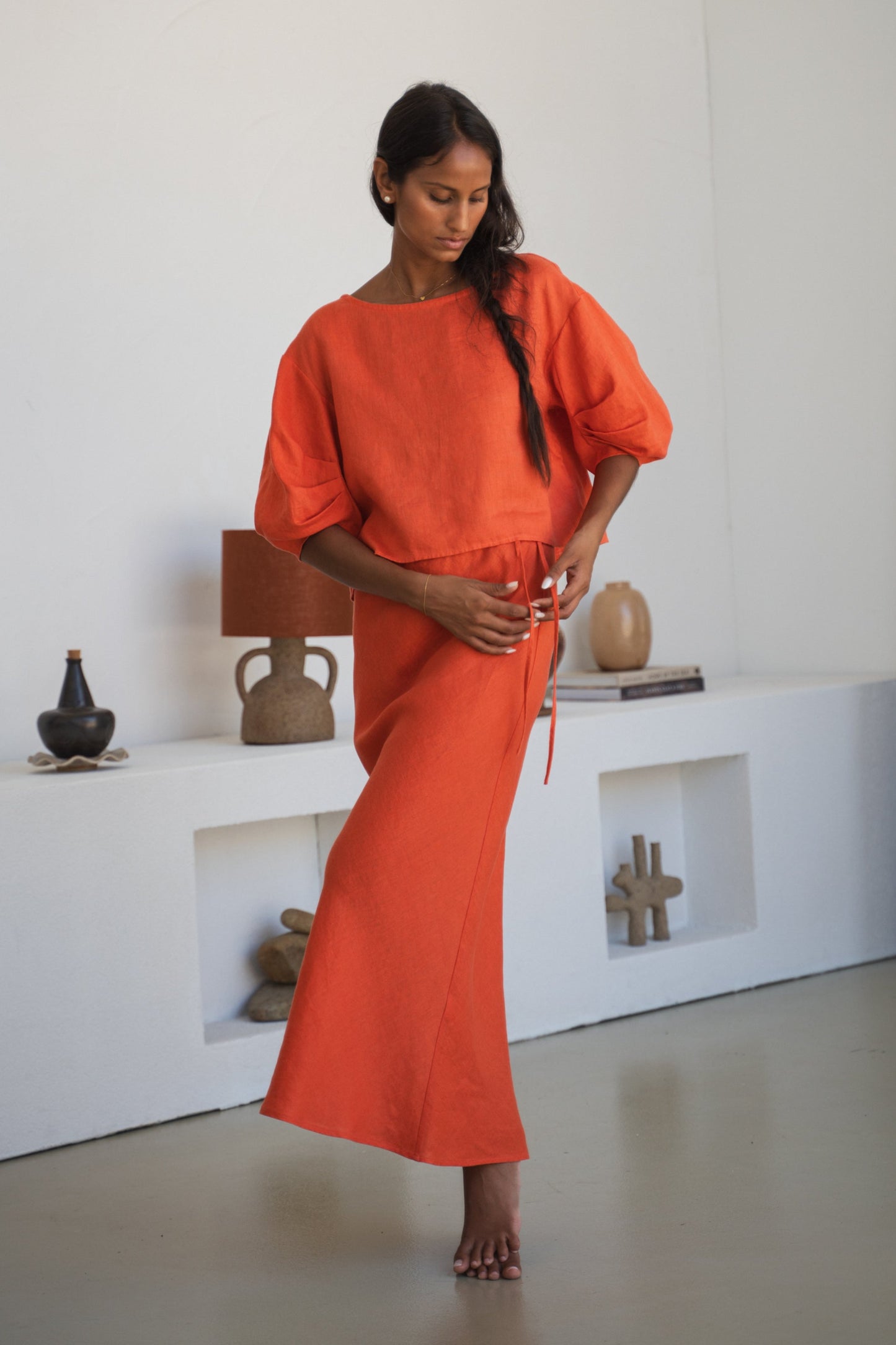 LILLY PILLY woman wearing Leia linen top in Spritz paired with Riley linen skirt with waist tie details