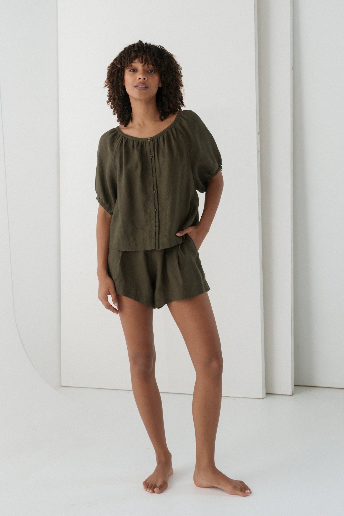 LILLY PILLY woman wearing a khaki Pia linen shirt top and Gaia shorts outfit against a white background