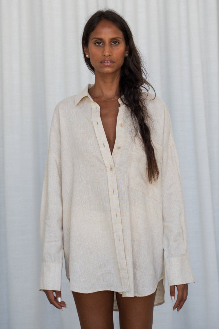 LILLY PILLY woman wearing oatmeal Kirra linen shirt with white curtain background