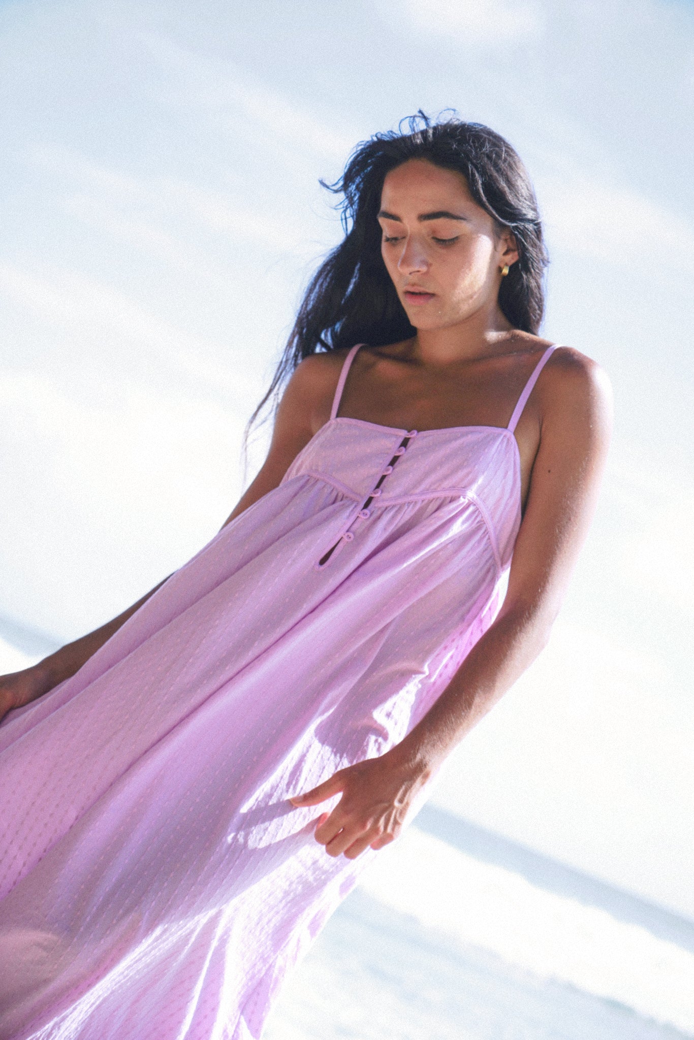 Woman wearing a light purple dress against a bright background
