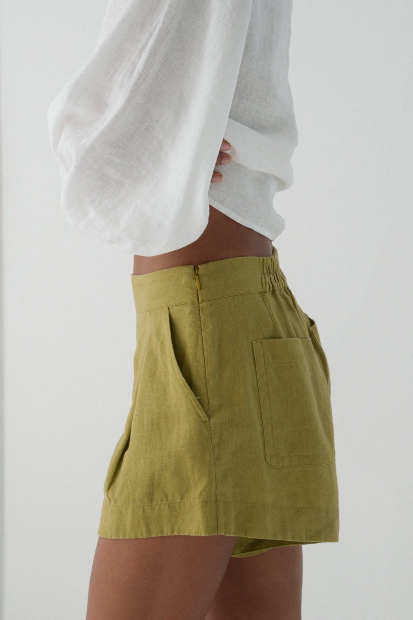 LILLY PILLY Gaia linen shorts in Olive green side view close up of hidden zipper