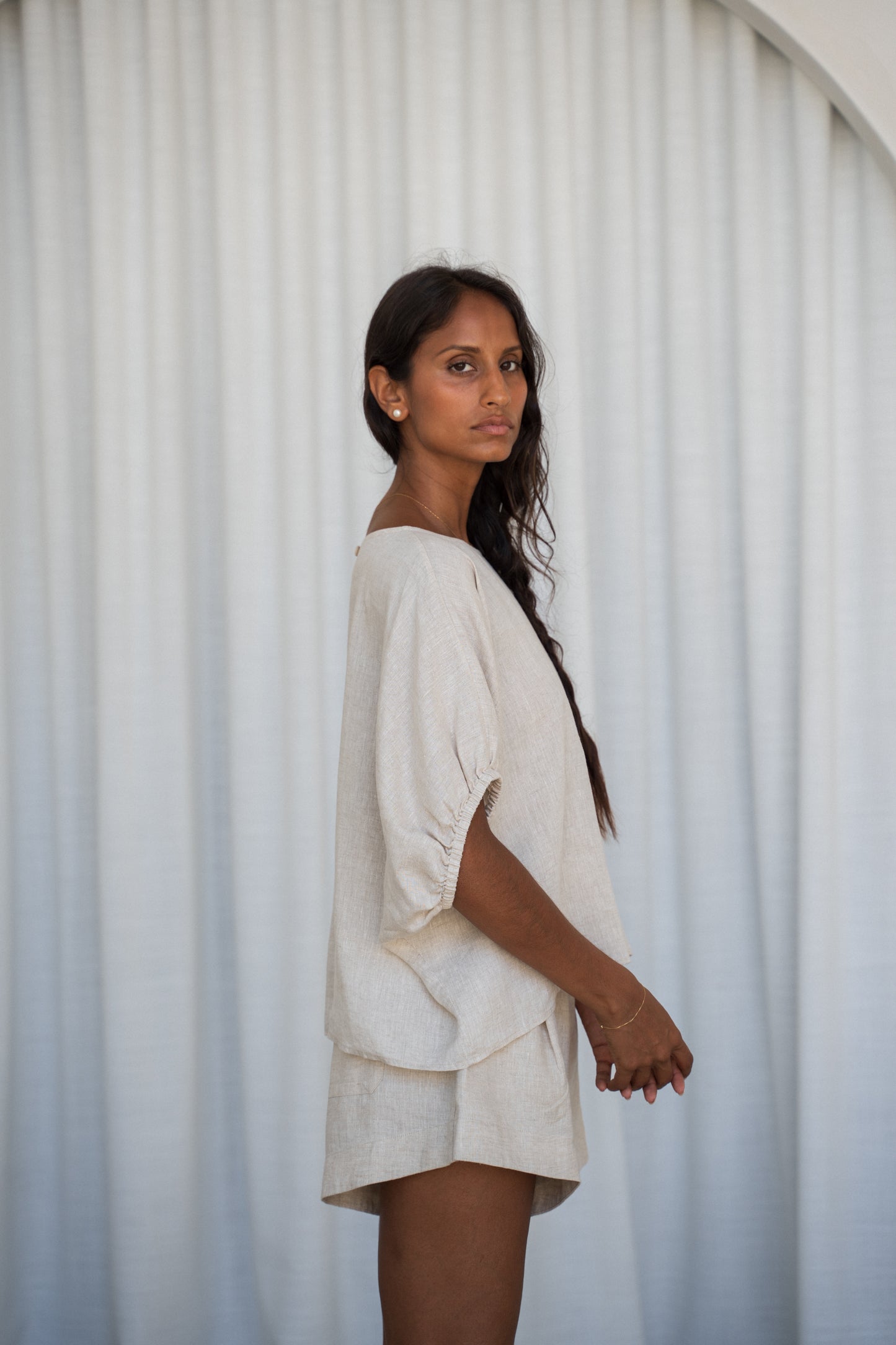 LILLY PILLY Tina linen top in Oatmeal side view with white curtain background