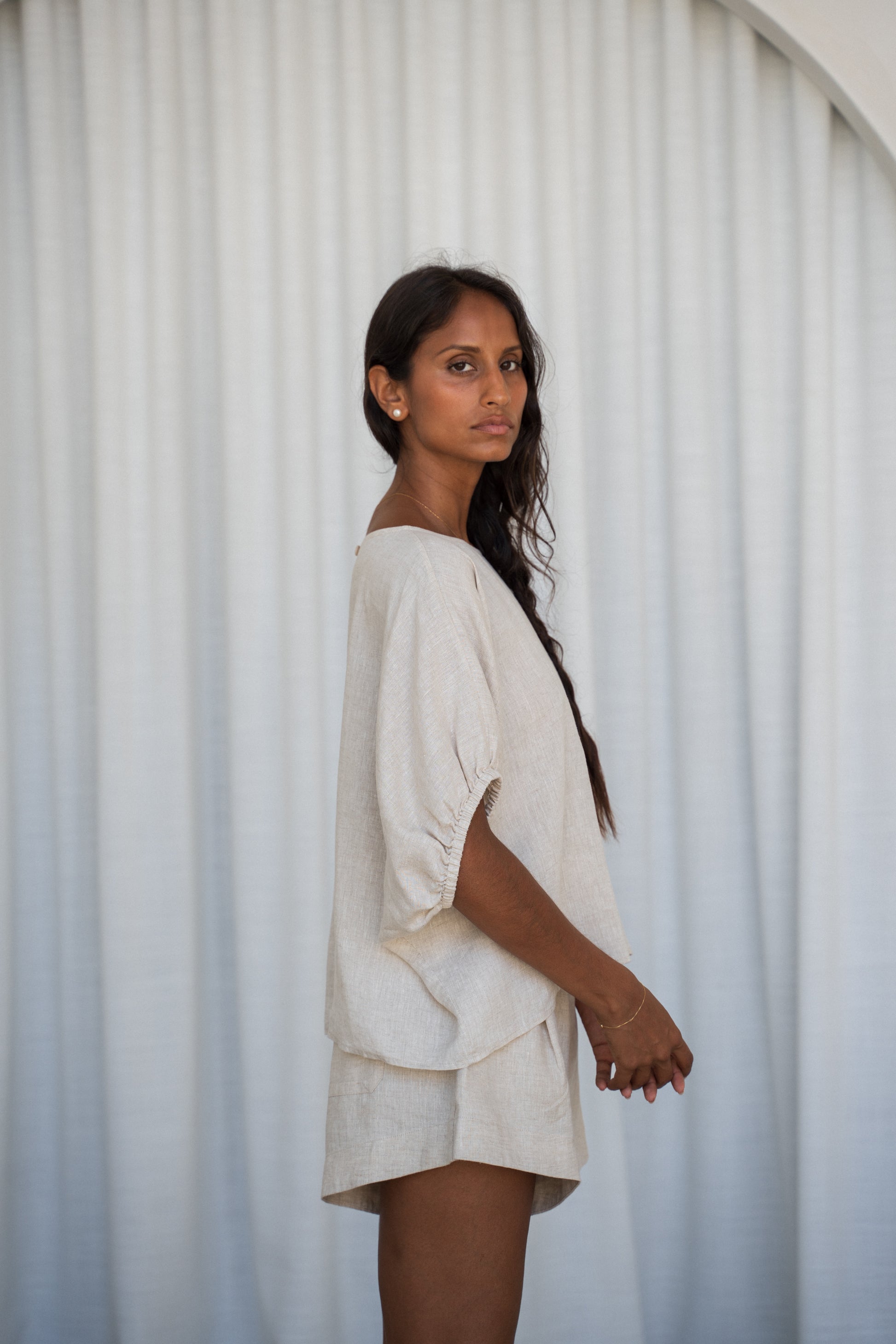 LILLY PILLY Tina linen top in Oatmeal side view with white curtain background