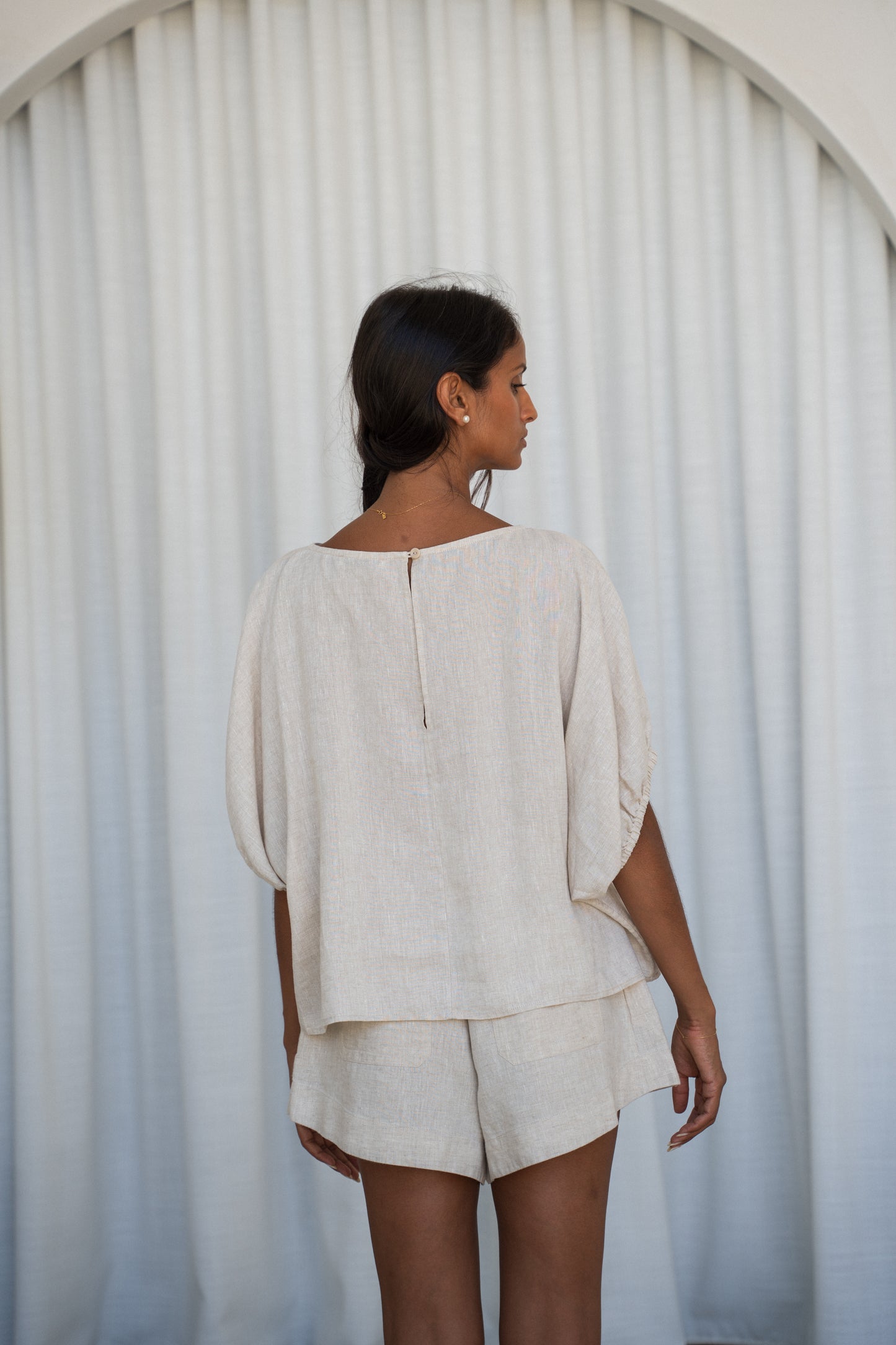 LILLY PILLY Tina linen top in Oatmeal back view with white curtain background