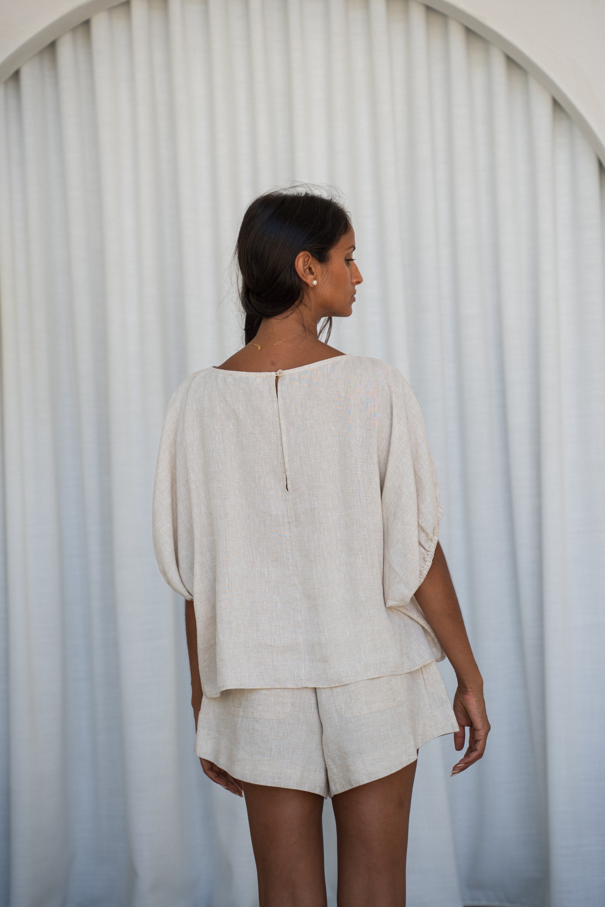 LILLY PILLY Tina linen top in Oatmeal back view with white curtain background