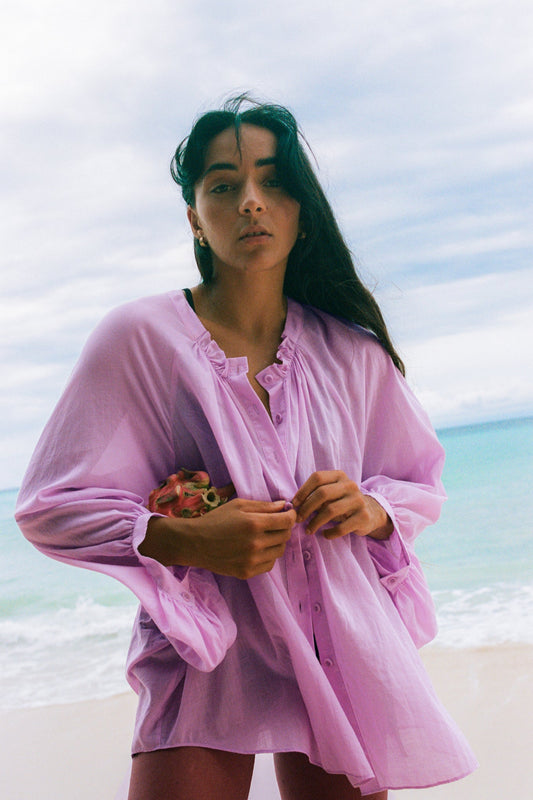 LILLY PILLY woman wearing a orchid Thalia cotton voile shirt by the seaside