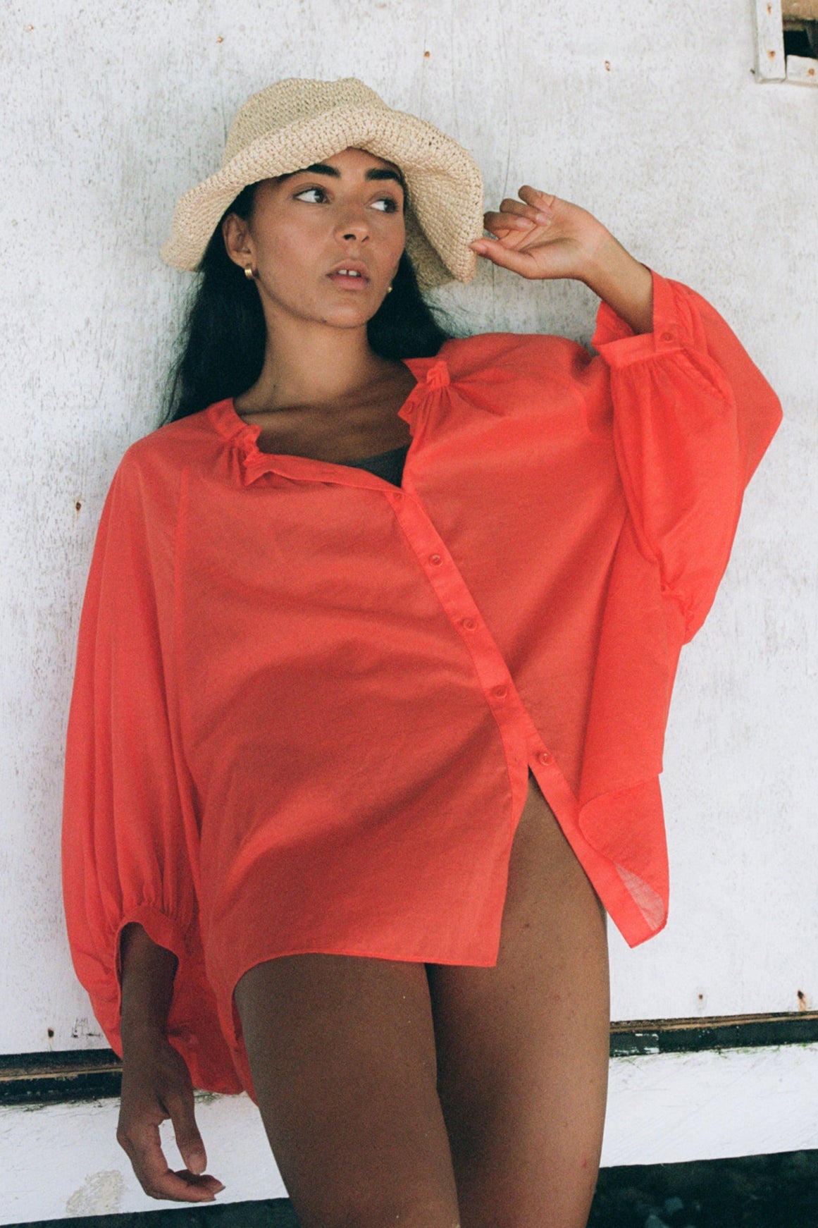 LILLY PILLY woman wearing a spritz Thalia cotton voile shirt showing front view while holding a straw hat